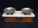 pair of antique silver plated scales on wooden box with black background
