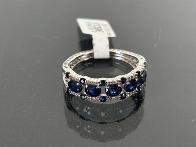 a close up of a ring on a table with a tag