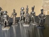 several figurines of soldiers are lined up on a table