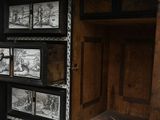 a black and white photo of a cabinet with pictures on it