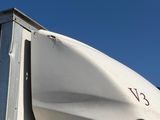 a white truck with a large white boat on top of it