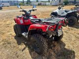 two atvs that are parked in the grass