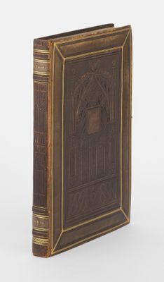 un vieux livre aux tranches dorées et à la couverture marron