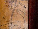 a picture of a wood carving of a person on a toilet seat