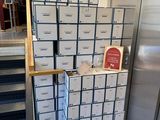 many boxes of pizza sitting on the floor in front of an elevator