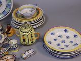 many different types of plates and bowls on the table