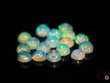 white fire oplite beads on a black background