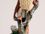 a figurine of a woman with a basket on her head