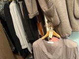 a picture of a closet with clothes hanging on a hanger