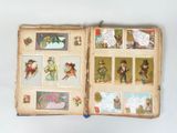an open book with pictures of people and animals on it