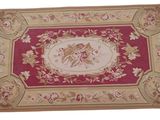 the rug is red and gold with a floral design on it