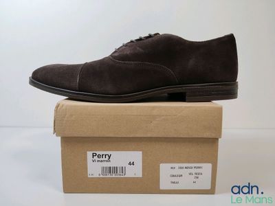 men ' s dress shoes in a box on a white surface