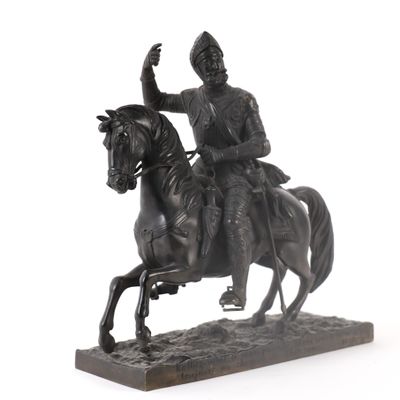a statue of a man riding a horse on a white background