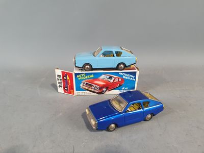 two toy cars sitting next to each other on a table