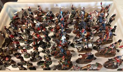 a lot of figurines in a plastic container on a table