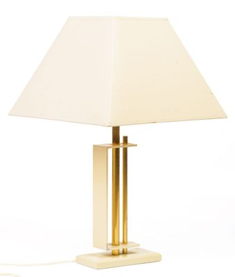 a white lamp with a gold base and a white shade