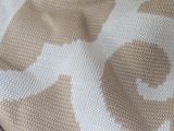 a close up of a knitted blanket with hearts on it