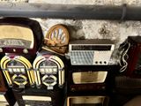 many old radio ' s sitting on a shelf next to each other