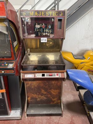 two old arcade machines sitting next to each other in a room