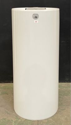 a white water heater sitting on the floor in front of a black wall