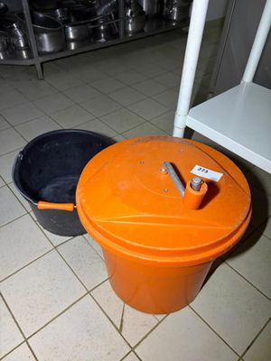 two buckets sitting on the floor next to each other
