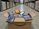 a box full of dvds sitting on top of a floor in a warehouse