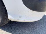 a close up of a car ' s front bumper and tire