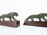 pair of bronze figurines of a lion and a tiger on wooden bases