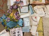 a pile of old books on the floor next to a teddy bear