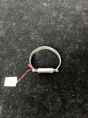 a close up of a ring on a table with a tag attached to it