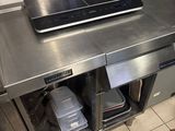 stainless steel counter top in a commercial kitchen with a laptop on it