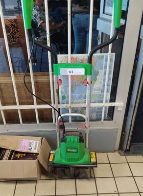 a green machine that is sitting in front of a door