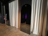 a room that has a lot of white curtains on the walls