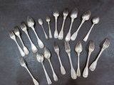 a lot of silver spoons and forks arranged in a circle