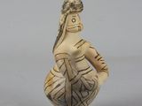 statue of a woman holding a vase in her right hand