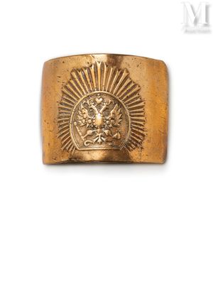 a close up of a gold ring with a sun on it