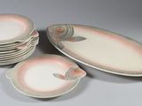 a stack of plates with a fish design on them