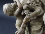 a statue of a woman holding a child in her lap