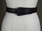 a white mannequin torso with a black belt on it