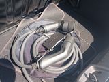 a hose in the trunk of a car with a suitcase in the back