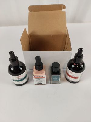 three bottles of liquid and a bottle of liquid in a box