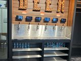 a beer dispenser with a lot of bottles on it