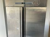 a large stainless steel refrigerator in the middle of a room