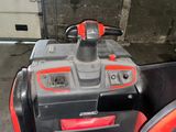 a red and black atv parked in a garage