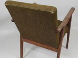 the back of a chair with a wooden frame and green upholstered upholstered seat