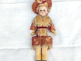 a doll that is laying down on a white sheet