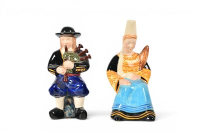 two figurines of a man and a woman standing next to each other