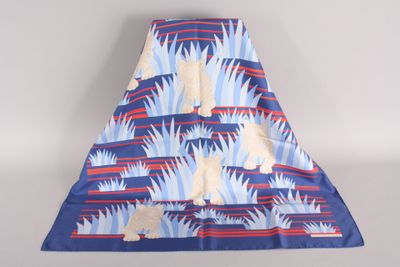 a blue and red blanket with a white dog on it