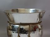 a silver bowl that is sitting on a table