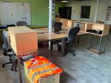 a room with a lot of desks and chairs in it